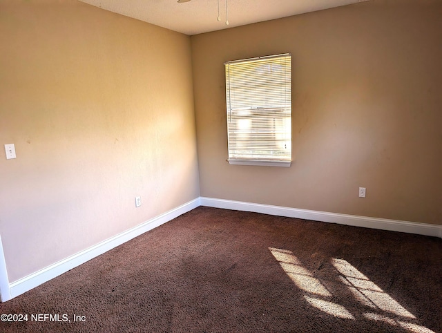 empty room with ceiling fan and carpet floors