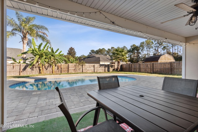 view of pool with a patio area and ceiling fan