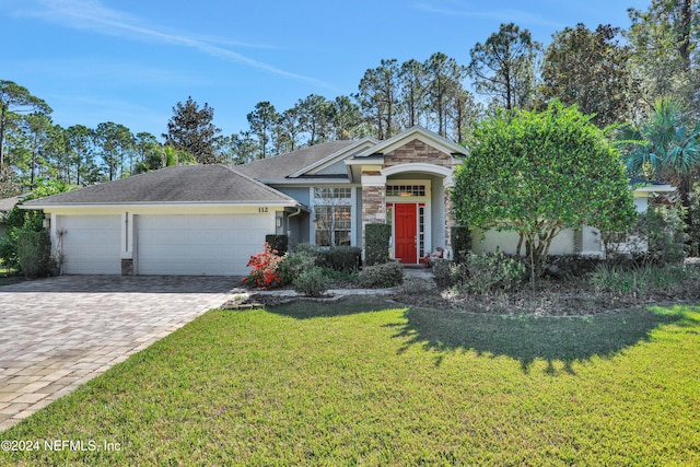 view of front of home with a garage and a front yard