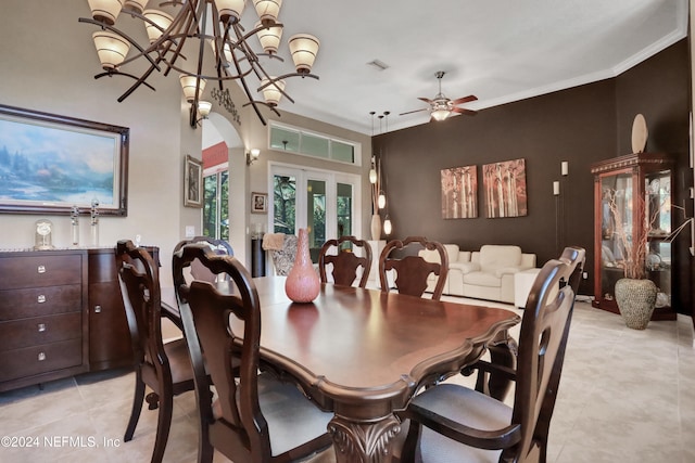 dining space featuring french doors, light tile patterned floors, ceiling fan with notable chandelier, and ornamental molding