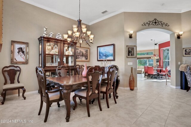 tiled dining room featuring an inviting chandelier and ornamental molding