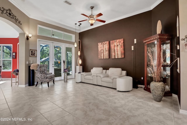 living room featuring ceiling fan, ornamental molding, light tile patterned floors, and french doors