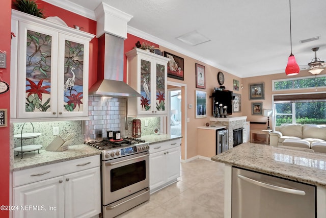 kitchen with appliances with stainless steel finishes, white cabinetry, and pendant lighting