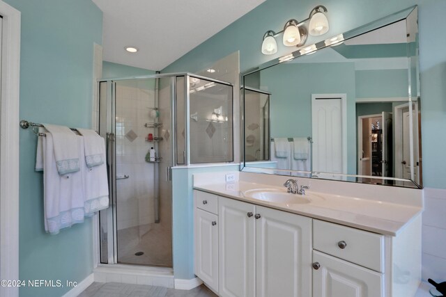 bathroom with vanity and walk in shower