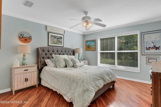 bedroom featuring a textured ceiling, ceiling fan, crown molding, and dark hardwood / wood-style floors