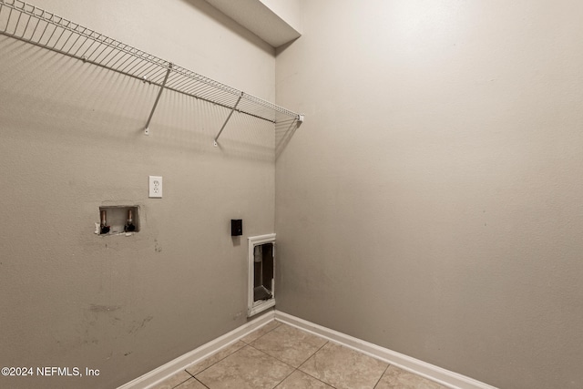 washroom featuring washer hookup and light tile patterned floors