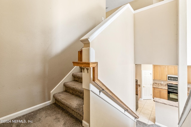 stairway featuring tile patterned flooring