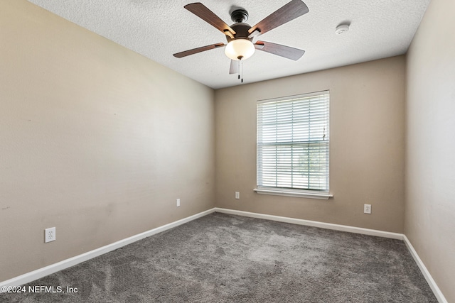 empty room with ceiling fan, carpet, and a textured ceiling