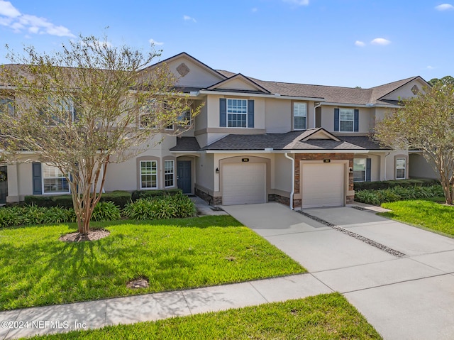 view of front of house featuring a front yard and a garage