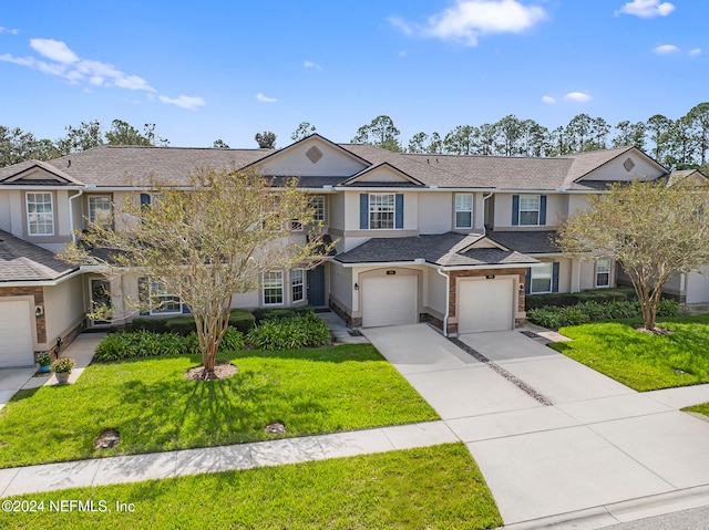 view of front of property with a garage and a front yard