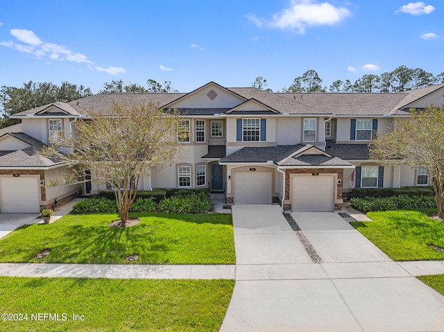 view of front of home with a garage and a front yard