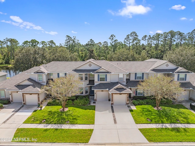 view of front of property featuring a front yard and a garage