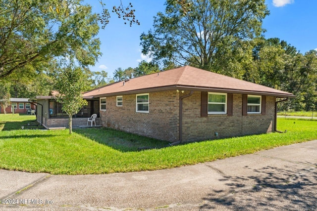 view of property exterior featuring a lawn