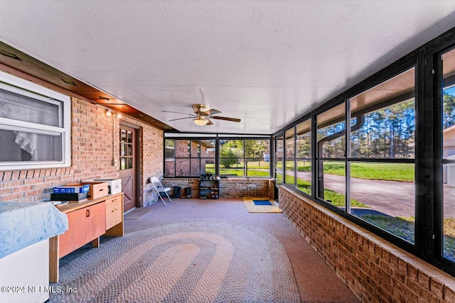 unfurnished sunroom featuring ceiling fan