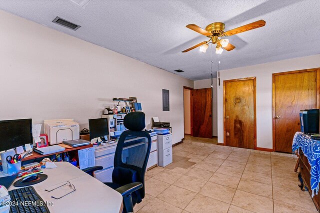 home office with ceiling fan, light tile patterned flooring, and a textured ceiling