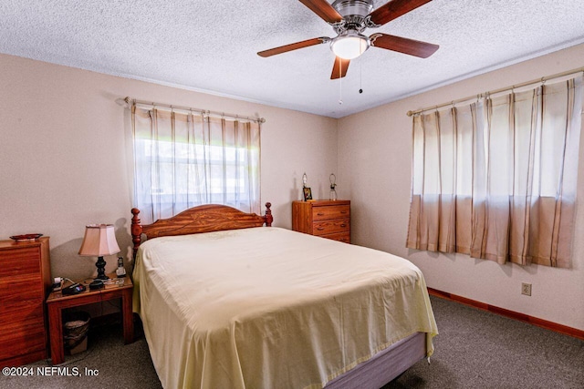 carpeted bedroom featuring ceiling fan and a textured ceiling