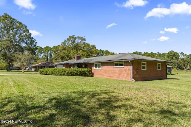 view of home's exterior with a lawn