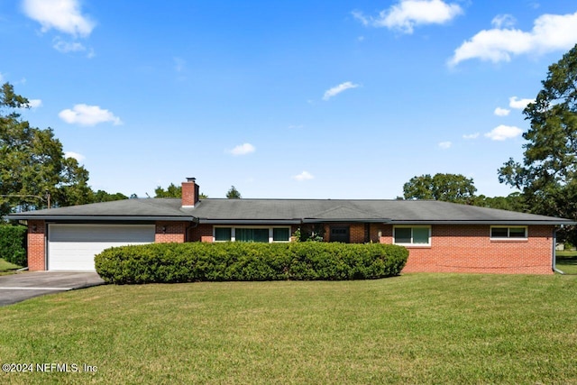 single story home featuring a front lawn and a garage