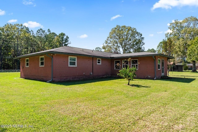 back of house featuring a yard