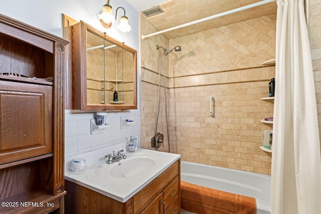 bathroom with shower / tub combo with curtain, tasteful backsplash, and vanity