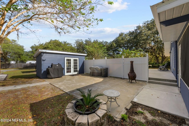 view of patio / terrace featuring an outbuilding and french doors