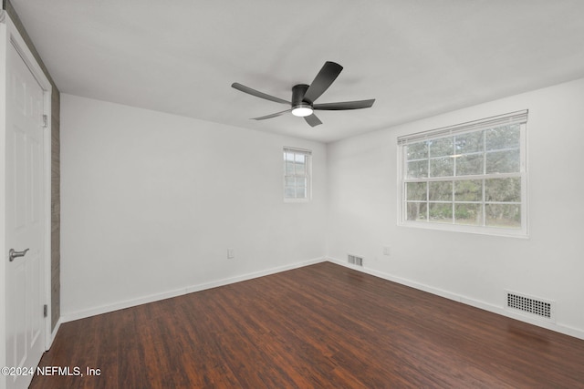 unfurnished room with dark hardwood / wood-style flooring and ceiling fan