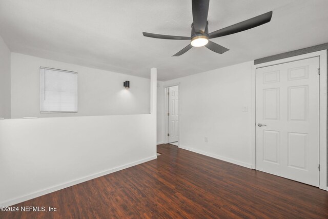 unfurnished room featuring dark hardwood / wood-style floors and ceiling fan