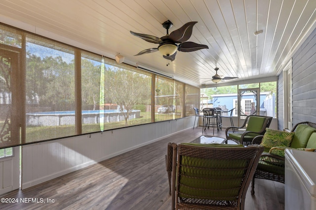 sunroom with ceiling fan, wood ceiling, and vaulted ceiling