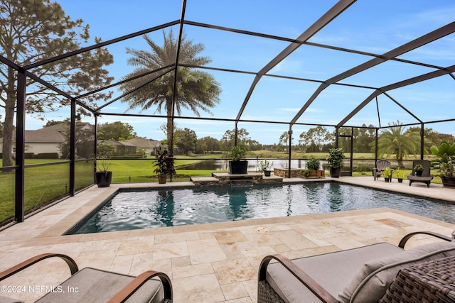 view of pool with glass enclosure, a patio area, and a lawn