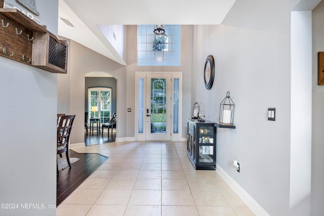 entrance foyer with a chandelier and light tile patterned flooring