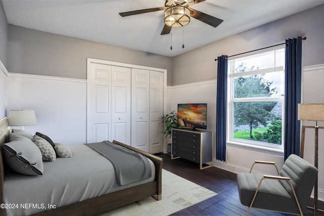 bedroom with ceiling fan, a closet, and dark hardwood / wood-style floors