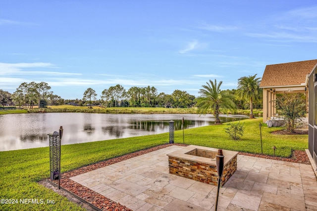 view of patio / terrace featuring a water view and a fire pit