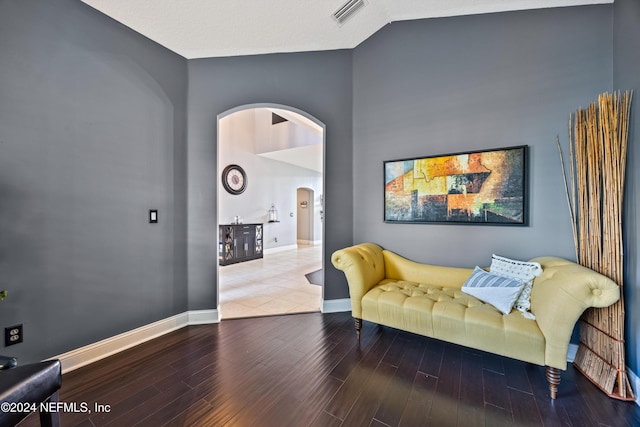 sitting room featuring hardwood / wood-style floors and lofted ceiling