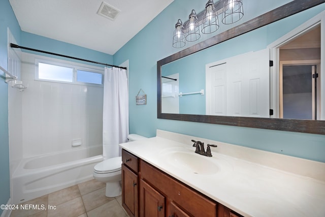 full bathroom featuring toilet, vanity, tile patterned floors, and shower / bath combo with shower curtain