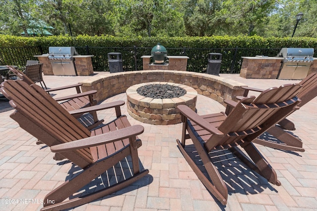 view of patio with grilling area, area for grilling, and an outdoor fire pit