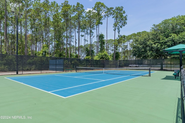 view of tennis court featuring basketball court