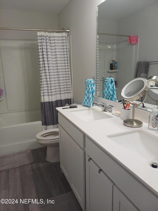 full bathroom featuring hardwood / wood-style floors, vanity, toilet, and shower / bathtub combination with curtain