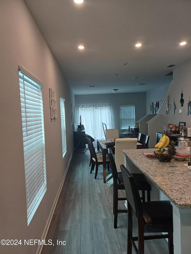 dining room featuring a healthy amount of sunlight and dark wood-type flooring