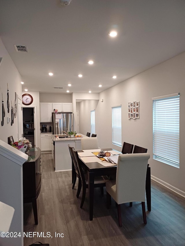 dining space with dark hardwood / wood-style flooring