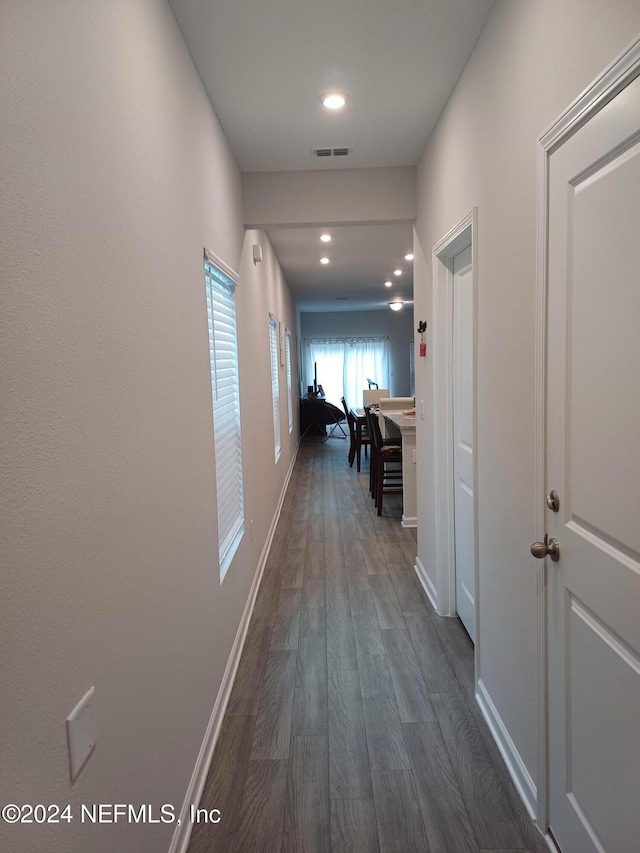 hallway with dark hardwood / wood-style flooring