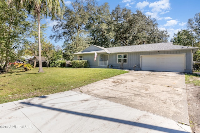 ranch-style home featuring a garage and a front lawn