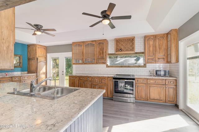 kitchen with decorative backsplash, french doors, stainless steel appliances, and sink