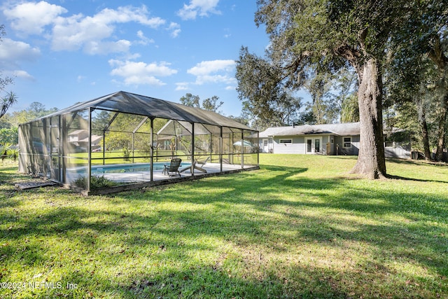 view of yard with glass enclosure