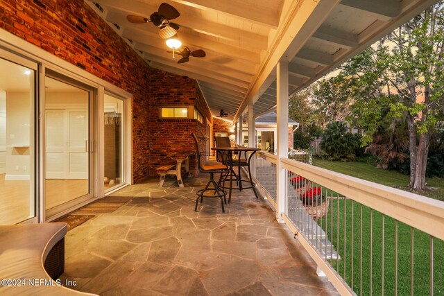 view of patio featuring ceiling fan and a balcony