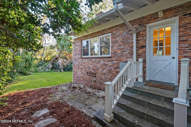 entrance to property with a yard