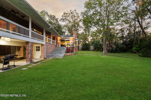 1124 Oriental Gardens Rd, Jacksonville, FL 32207 - view of grassy yard with a patio and a balcony