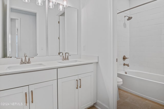 full bathroom featuring tile patterned flooring, toilet, vanity, and tiled shower / bath