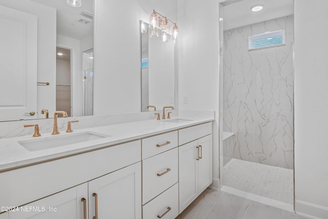 bathroom with tiled shower and vanity