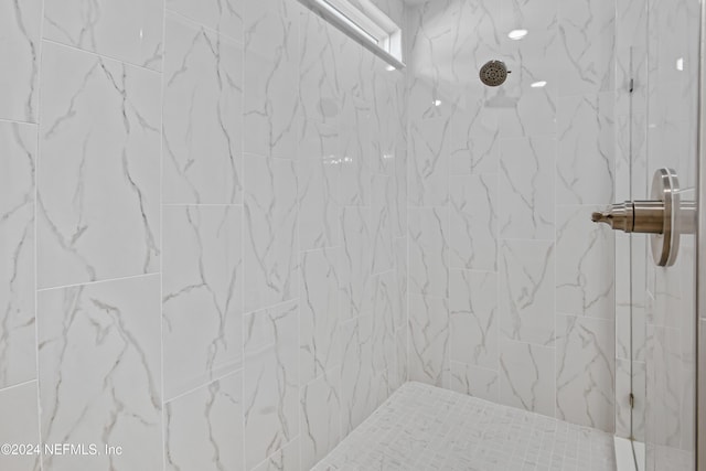 bathroom with a tile shower