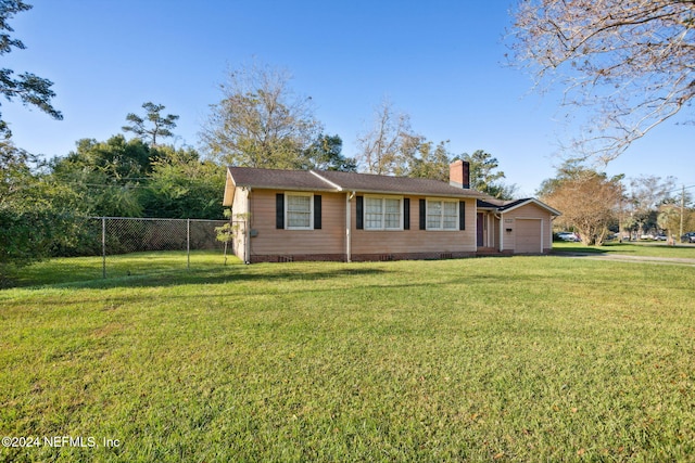 ranch-style house with a garage and a front lawn